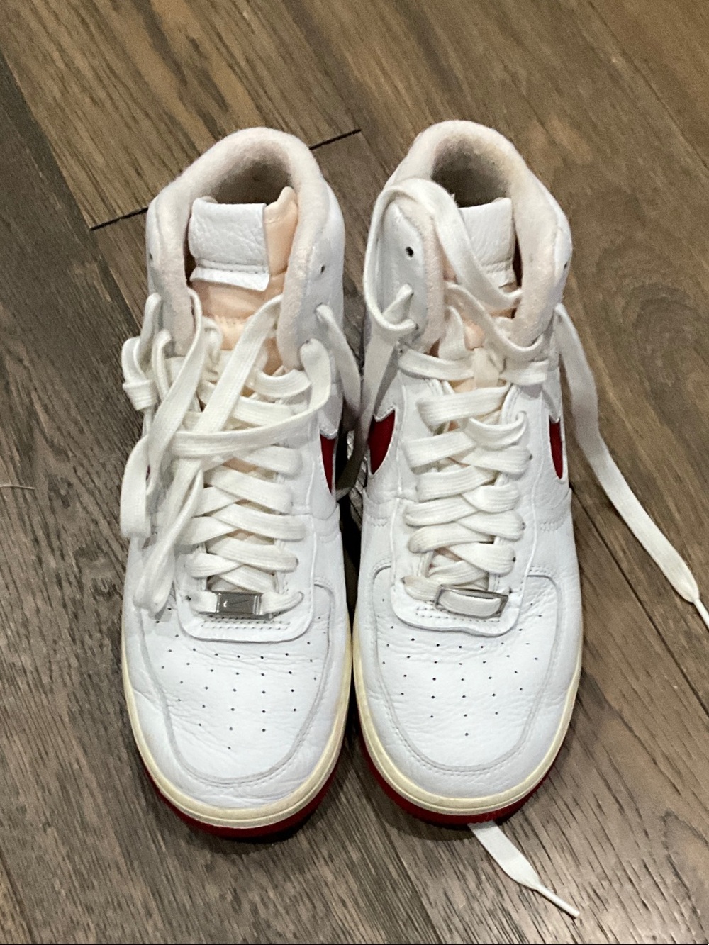 Nike White High-Top Sneakers with Red Swoosh
